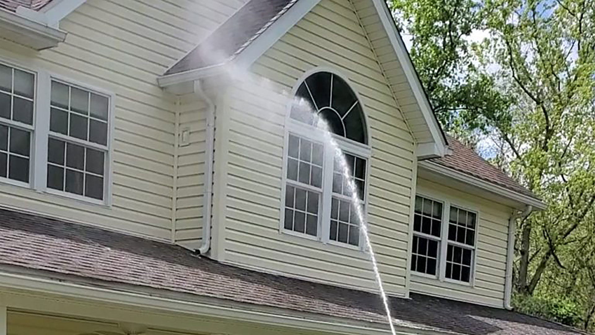 Soft wash house cleaning on a two-story home