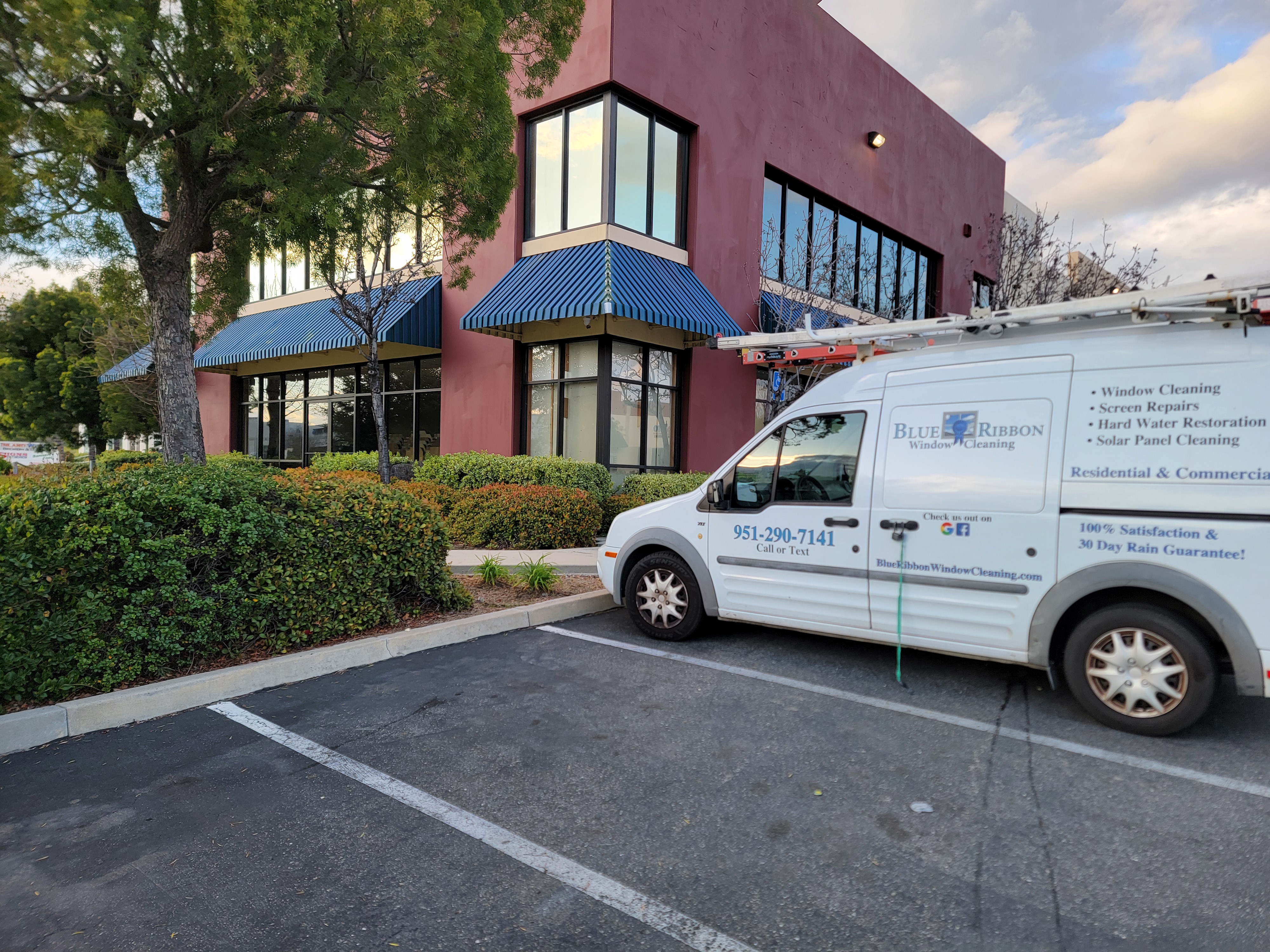 Blue Ribbon van at a commercial window cleaning job