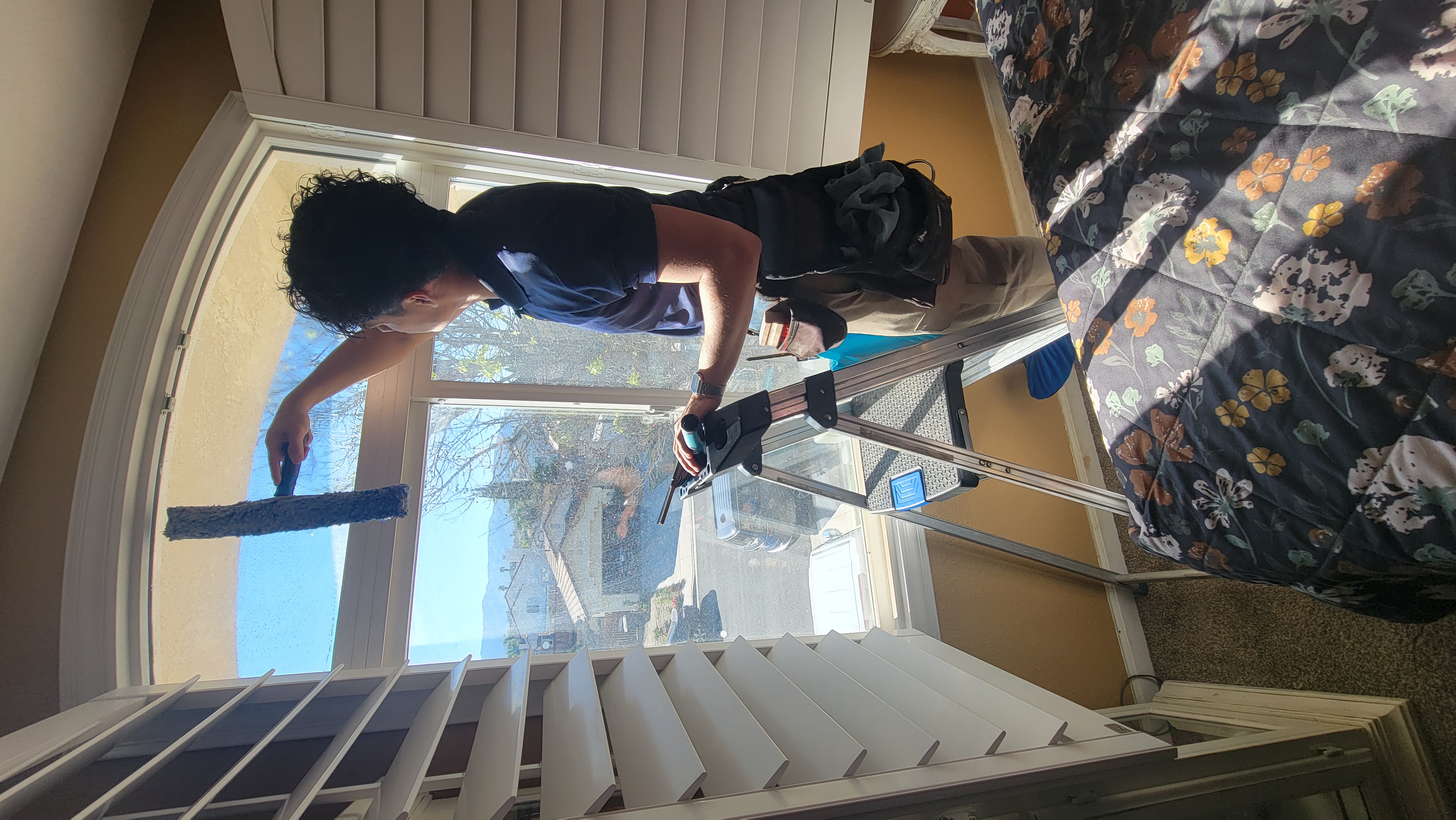 Blue Ribbon technician hand-detailing exterior glass on a Temecula Valley home